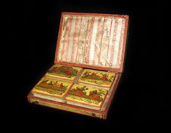 An arte de povera painted Venetian box with four individual card cases inside. Interior cover lined with silk; the box and interior card cases all with original hinges. The whole painted yellow with rid trim with a central figure holding a staff and