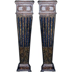 A pair of carved wood, faux-marbleized pedestals (piedistalli)