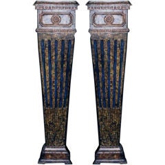A pair of carved wood, faux-marbleized pedestals (piedistalli)