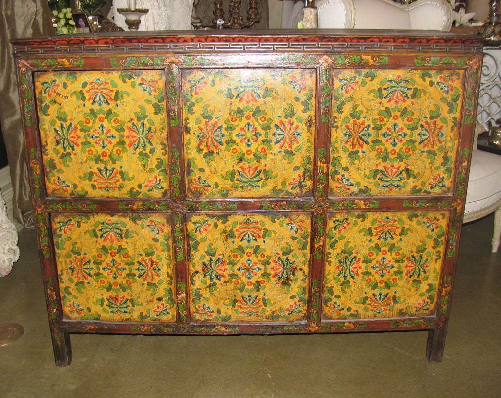 Wonderful brightly handpainted Tibetan storage chest with 4 doors. Each front panel indtricately detailed with stylized floral and leaf decoration.