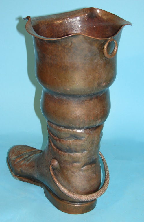 An Italian hammered copper umbrella stand in the form of a boot made and signed by Egidio Casagrande.