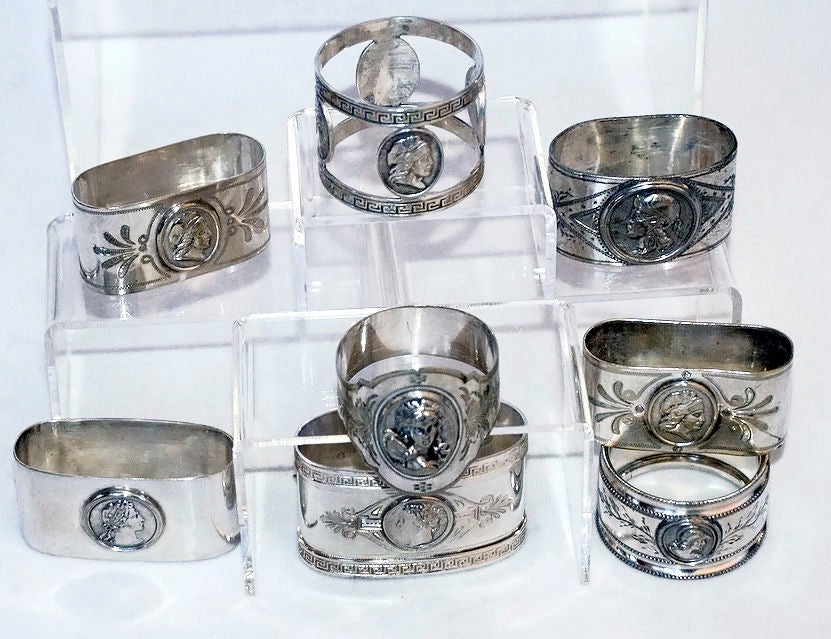 8 Medallion Motif Napkin Rings Coin And Silver Silverplate In Excellent Condition In New York, NY