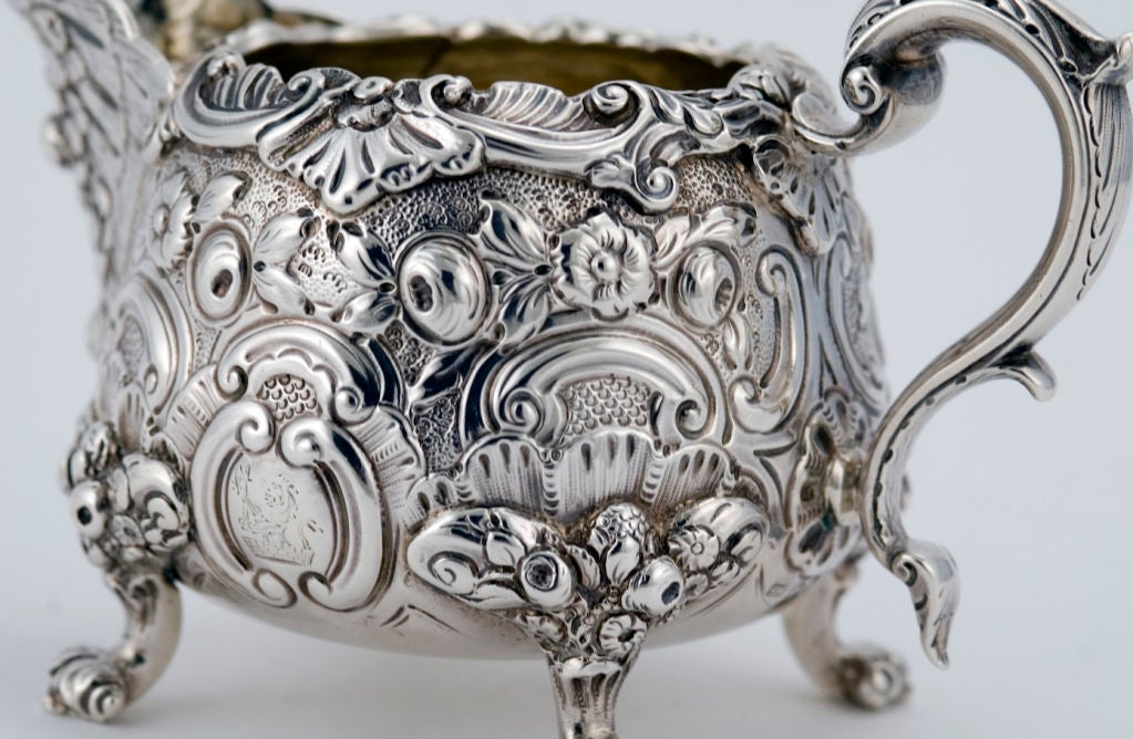 A fine circa 1807 Georgian sterling silver coffee - tea set Samuel Whitford, of London, England, comprising a coffee pot, teapot, sugar bowl, creamer and stand (with burner) for kettle, the bodies chased and repousee in a foliate and floral motif,