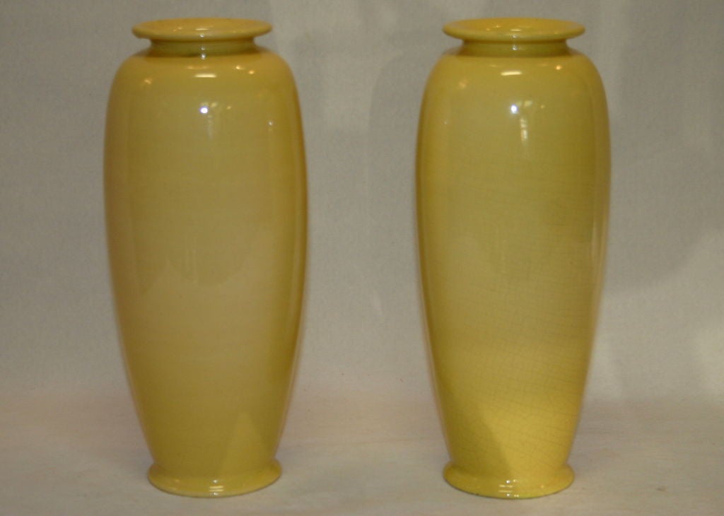 Matched pair British art pottery vases with swallows on cheerful yellow ground. Produced at Ault Pottery which Christopher Dresser designed for. Impressed export and maker's marks.