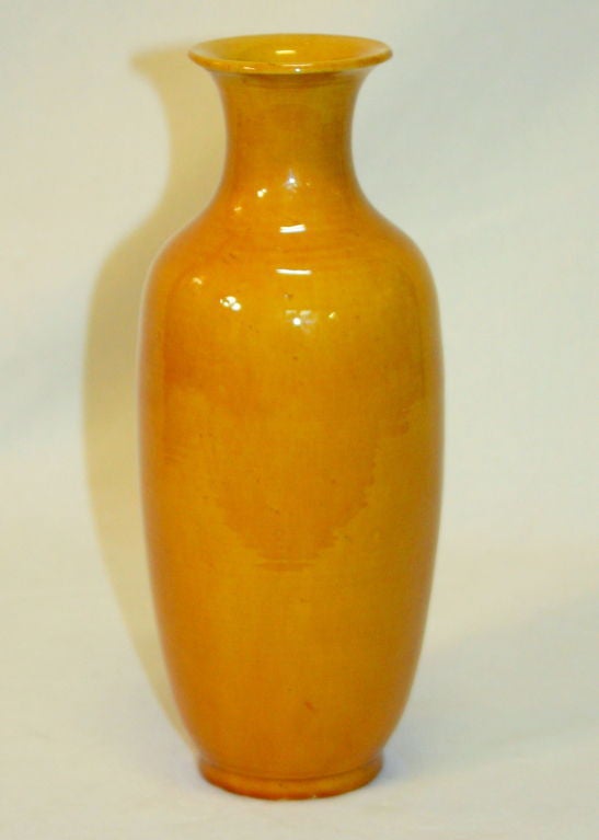 Antique Chinese porcelain vase in warm amber yellow monochrome glaze.