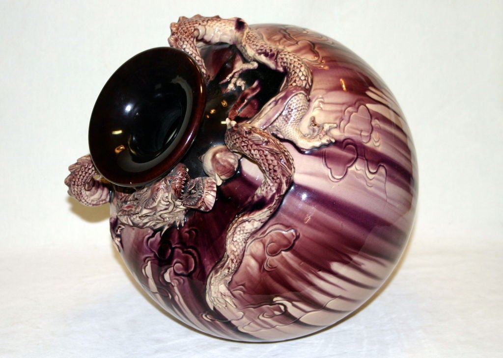 Spherical Awaji pottery vase with aubergine glaze and eternal dragon clutching the flambing pearl. Hand thrown.