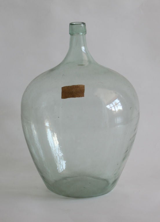 Glass has a slight blue/green cast.  The imperfections in color and shape are characteristic of antique blown glass.