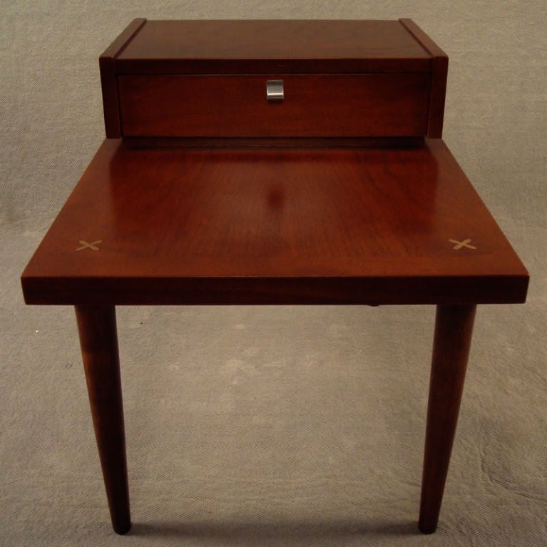 Teak end table manufactured by American of Martinsville - in Martinsville, VA.  Extremely well constructed and sturdy.  Upper section with dove-tailed drawer.  Cross inlaid motifs on corners.<br />
<br />
Drawer measures 17