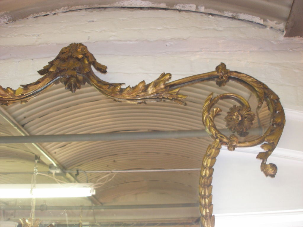 Late 19th C. English curved wood frame mirror having garlands of flowers.  Gilded.