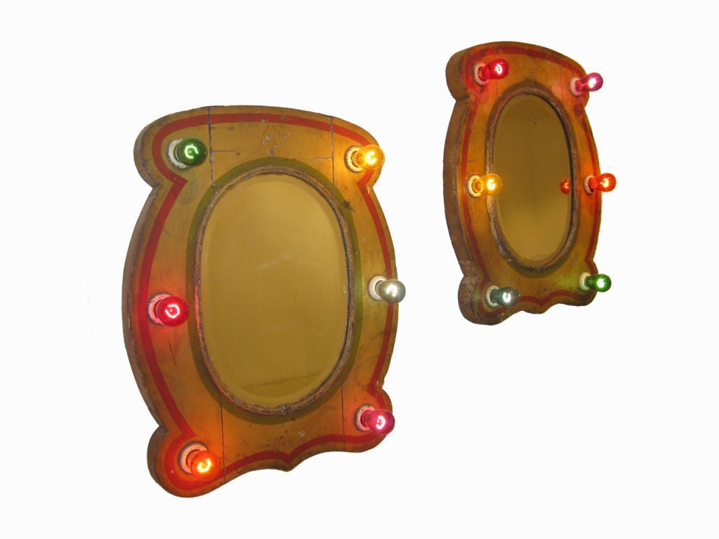 Circa 1900 pair of wood carnival carousel mirrors in exquisite and original age cracked red and mustard paint with rope cord framing, original boiler plate glass, all in original surface, new porcelain socket rewiring. PRICED FOR THE PAIR