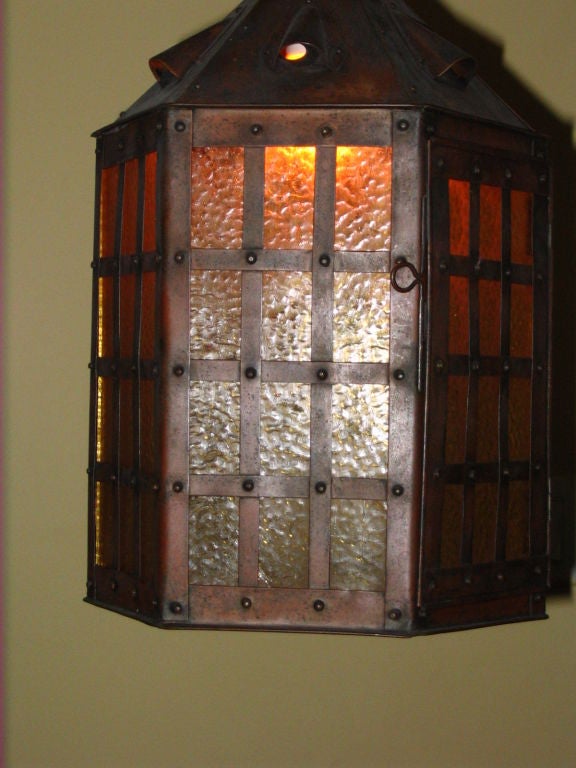 A beautiful original patina copper and hammered amber glass light havindan octaganal design.Beautiful copper grid work over glass. Great quality fixture that can be flush mounted or hung from the heavy copper chain that is original to fixture.