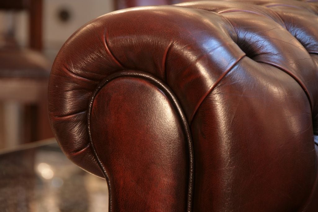 Spectacular English Chesterfield sofa with original tufted leather upholstery and bun feet.So comfortable!