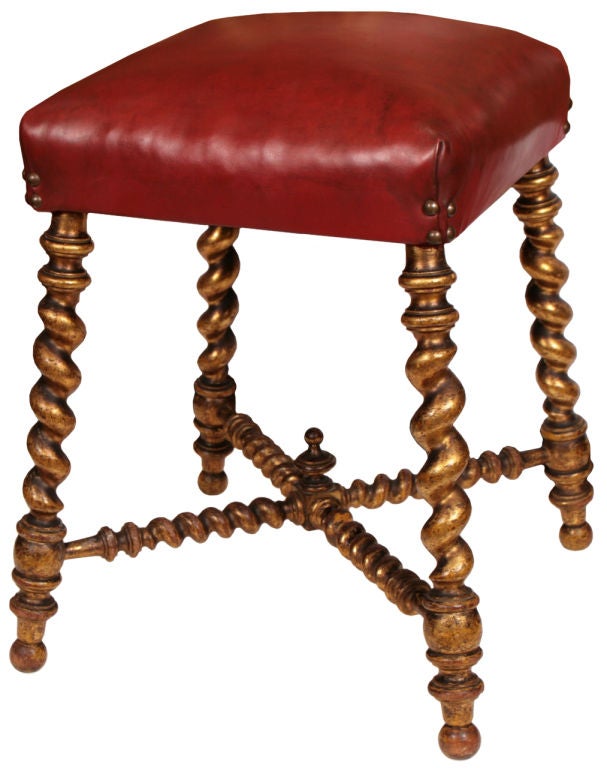 Darling pair of antique French Napoleon III period hand carved and gold leafed stools with patined red leather upholstery.