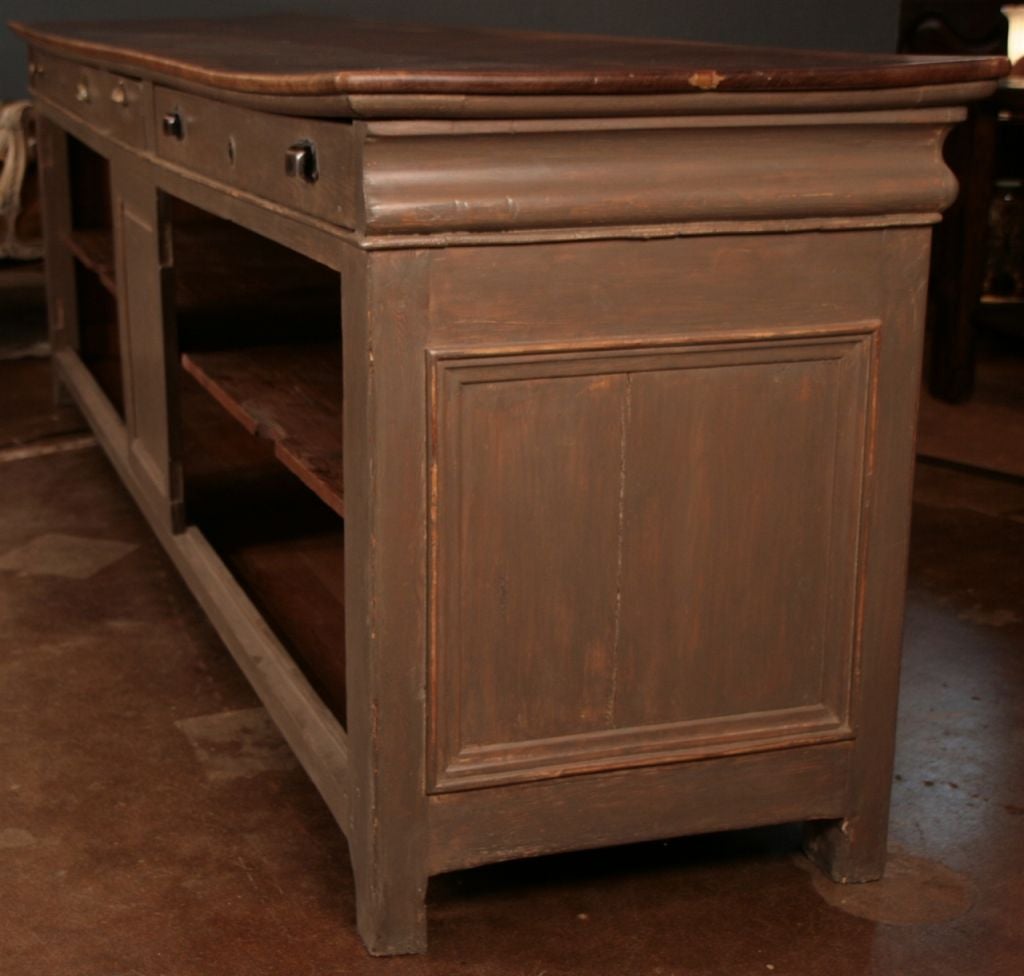 French Louis Philippe period restaurant kitchen counter, with beautiful solid walnut top, hand painted and patined fir base, three drawers on back side and single long shelved cabinet.
