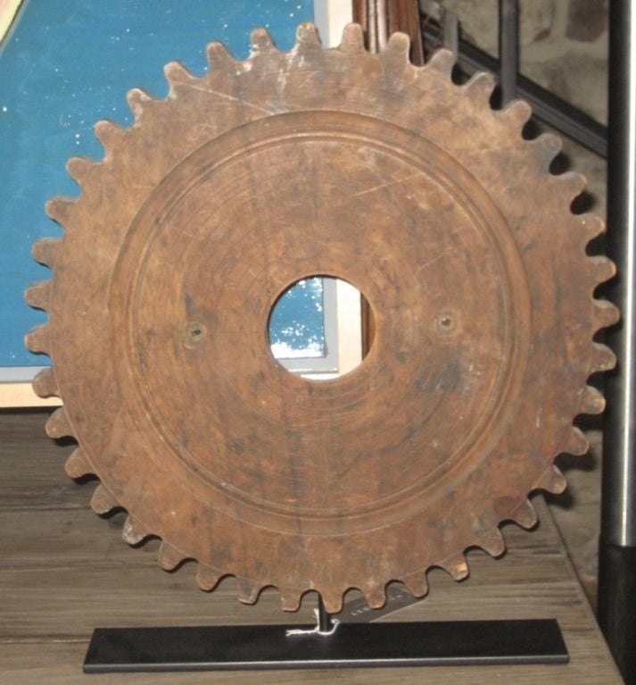 Vintage wooden gear mounted on a steel base. Gear is from the 1900 from Belgium.