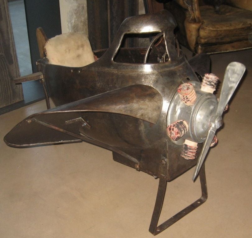 Vintage metal carnival plane from the 1920's. Plane came from a vintage carnival ride. The plane has a movable propellor and upholstered seat.