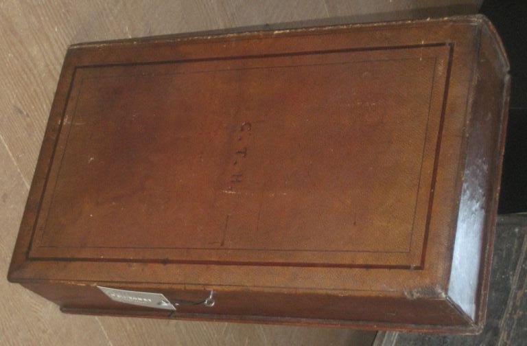 Large leather book box with lock and key. Book is bound with leather and stamped G.T.H.

