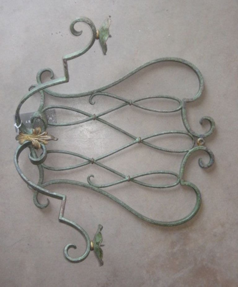 Vintage iron sconce with two candle holders. Iron is painted green with gold accents and dates back to 1890-1900's.