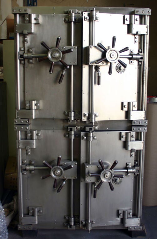 Vintage bank safe made by Herring Hall Marvin Safe Co. The vault was custom built for a bank in San Diego.  This piece was designed in 1909 and has been refurbished on the inside and outside where it is black, but the orignial patina of the doors