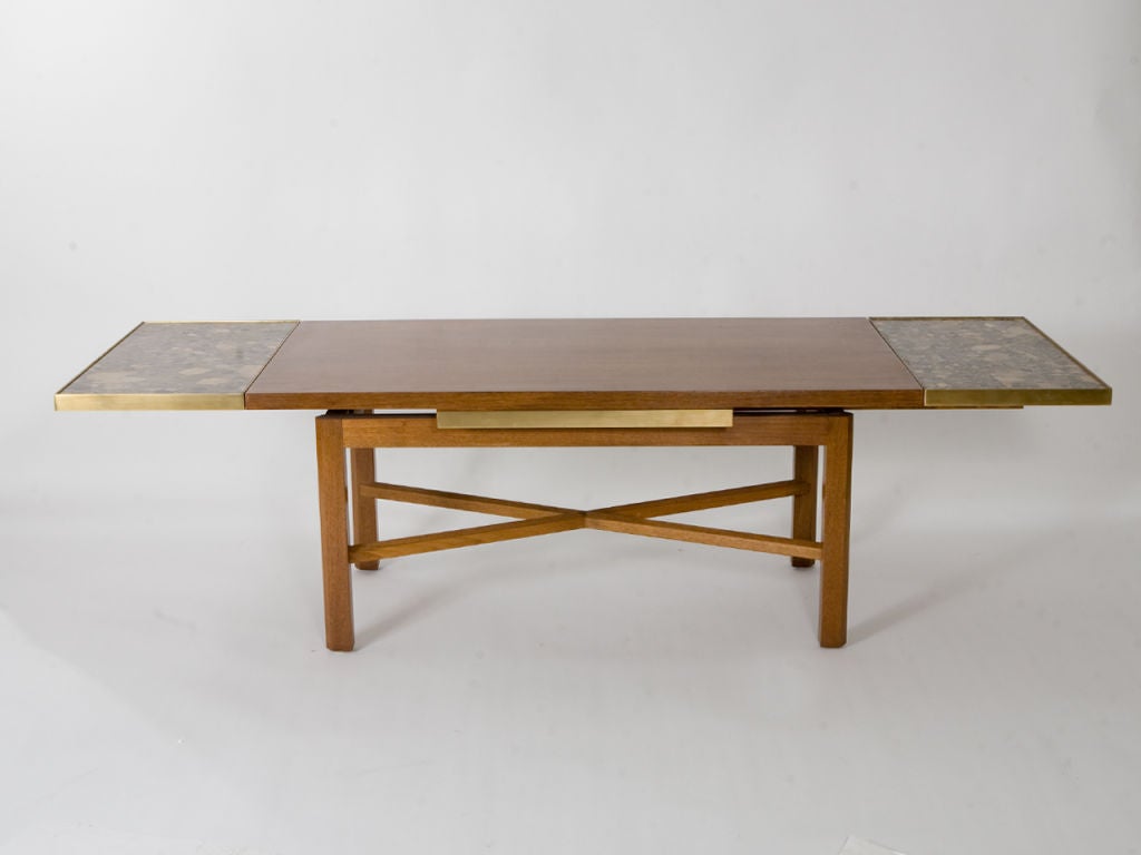 Sleek, Mid-Century walnut coffee table by Ed Wormley for Dunbar with beautifully patterned breche marble, brass edged, slide out extensions.<br />
68.75