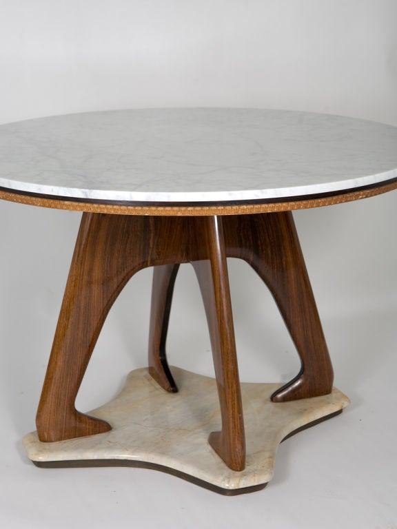 Sculptural round Italian table, white marble top, wood shaped legs and white marble base. Attributed to Dassi.