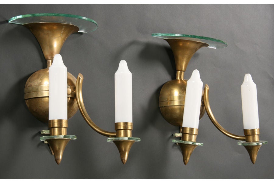 Pair of French Art Deco style brass and glass sconces with white glass faux candles. Matching chandelier available.