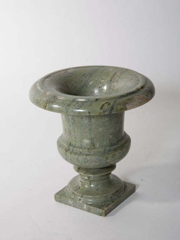Pair of classically shaped green granite urns in beautiful shades of green with white and deep grey accents.<br />
Base - 6