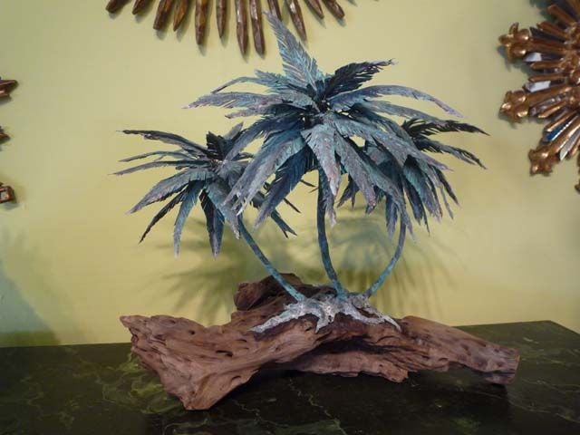 A very decorative copper palm tree sculpture on driftwood.<br />
<br />
Please visit our website at www.fshenemaderantiques.com .