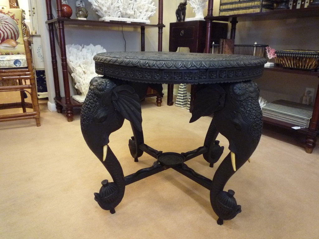 A well carved Anglo Indian ebonized elephant table. Original tusks.