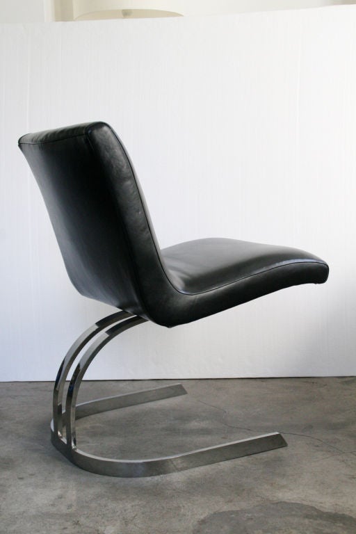 Set of six chrome cantilevered dining chairs, circa 1970s. In the manner of Preben Fabricius and Jørgen Kastholm. Newly reupholstered in smooth black leather. Clean lines, very minimalistic, and super unique! Seat looks like it's just floating off