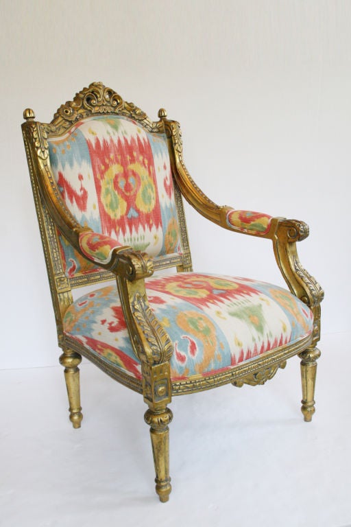 Pair of French Louis XVI gold gilded parlor chairs, c. 1930's, France. This is a rare find, due to there size, age, and beauty dating back to the early 1900's. We have a set of 4 arm chairs total, sold in pairs, as well as the matching sofa sold