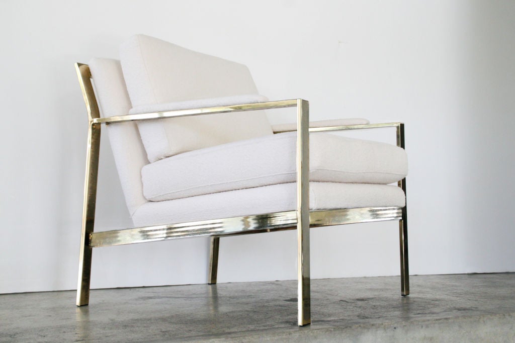 Pair of Brass Milo Baughman Arm Chairs, c. 1970's USA. Beautiful brass frame with removable seat and back cushions. Newly reupholstered in a fine cream nubby fabric, imported from Scotland. Zippers for easy cleaning. Very chic and comfortable.<br