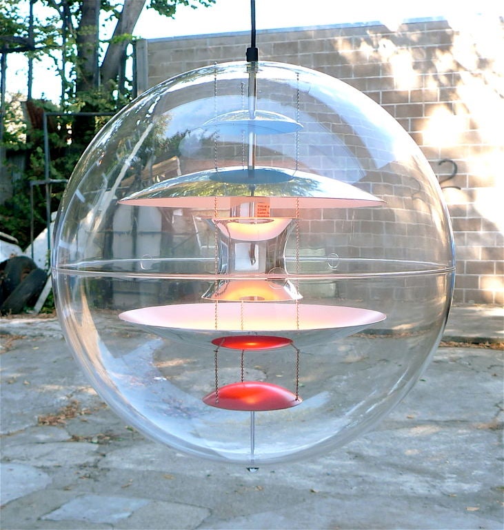 Unique and magical light terrarium comprised of a transparent acrylic globe containing suspended aluminum reflectors formed from hemispherical wedges lacquered blue and orange on one side and chromed on the other.  Also available in smaller 16