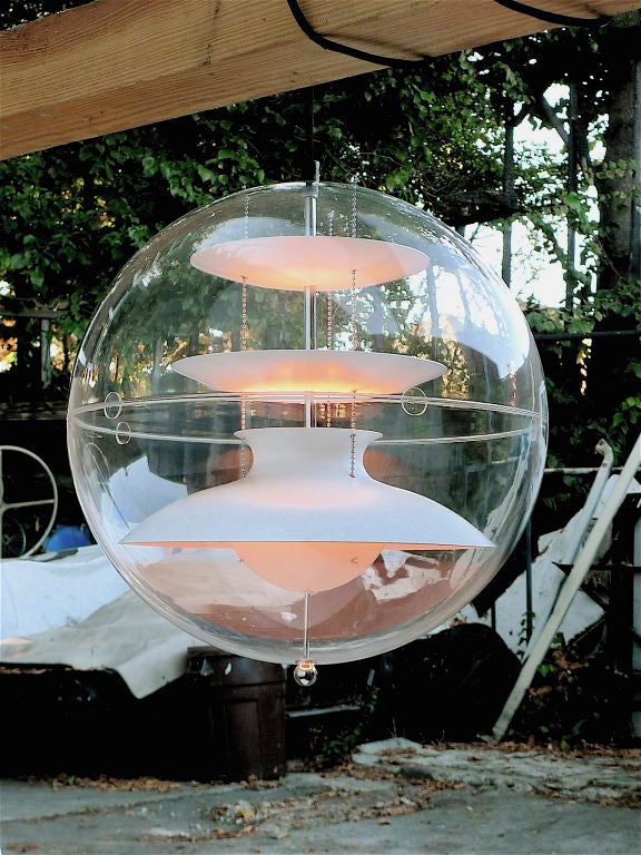 Classic Panton 1969 design.  This the new VerPan licensed variation production.
Unique and magical light terrarium comprised of a transparent acrylic globe containing suspended aluminum reflectors formed from hemispherical wedges lacquered white.