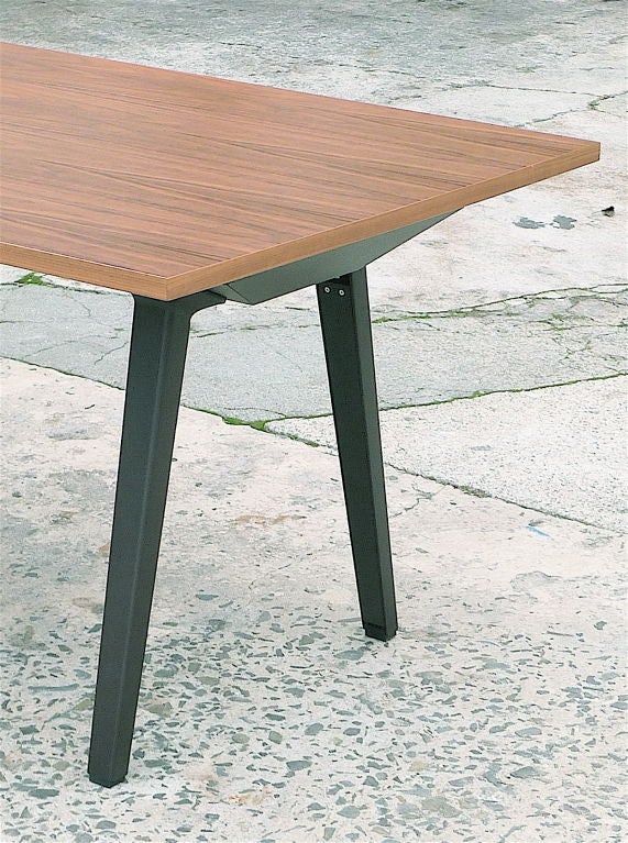 Multipurpose table by the Bouroullec brothers can also serve as a desk with discreet support system providing space for cable maintenance while maintaining generous leg clearance. Exotic grain walnut veneer top with dark chocolate powder-coated