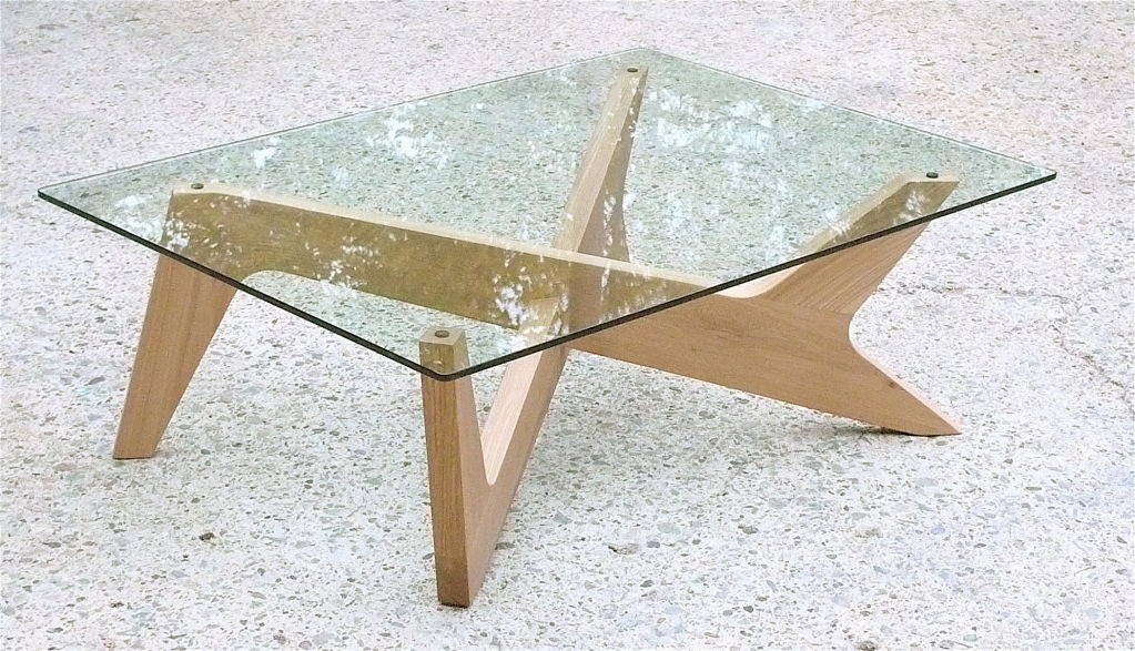 Unique and practical Matthew Hilton Design Studio coffee table.  Now out of production, Hilton's scultpural table design provides an interesting and practical alternative to the classic but worn Noguchi coffee table statement.  The bold form and
