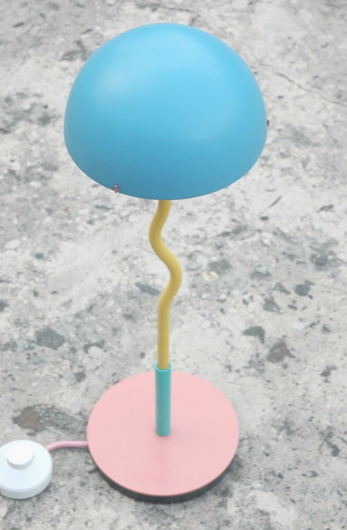 Unique pair of Sottsass/Mendini inspired table lamps by Products of London.  Retains label.  Eighties sensibility comes through loud and clear in pink, yellow and blue with  distinctive squiggle stem and original matching pink power cord.