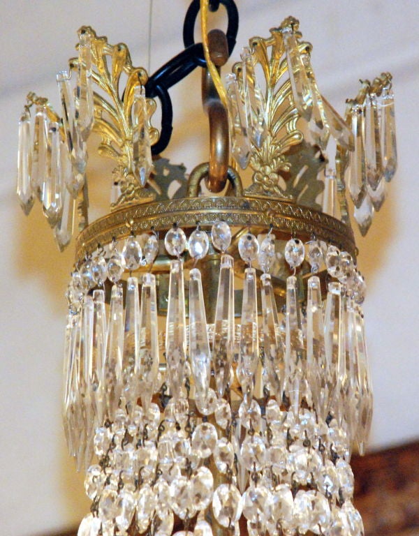 Antique French bronze doré and Baccarat crystal Empire chandelier.