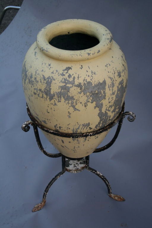 1920's concrete oil jar with original paint in original iron stand.