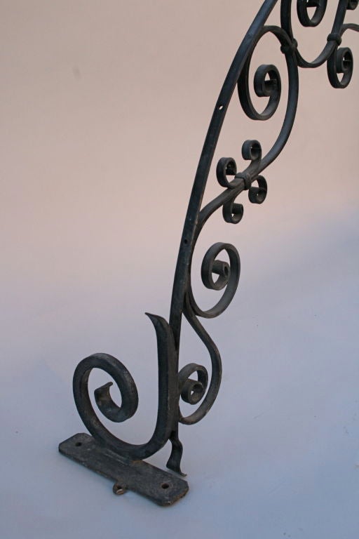 Beautifully hand-wrought iron arch with quality ironwork.  Would be wonderful in a garden atop a pair of columns.