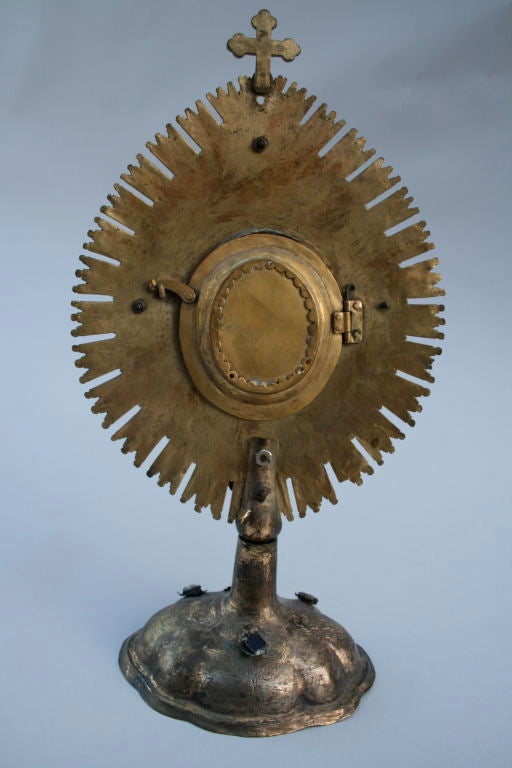 Primitive South American monstrance tooled in silver and brass with inset aquamarines.