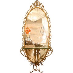 Gilt wrought iron oval mirror with a console