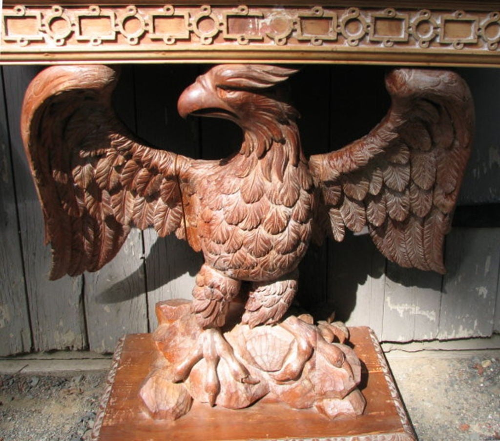 Exceptional pair of Georgian style carved pine rectangular console tables, having green marble tops set on a conforming geometric relief carved apron supported on robustly carved facing eagles, grasping a rockery and atop<br />
an egg and dart