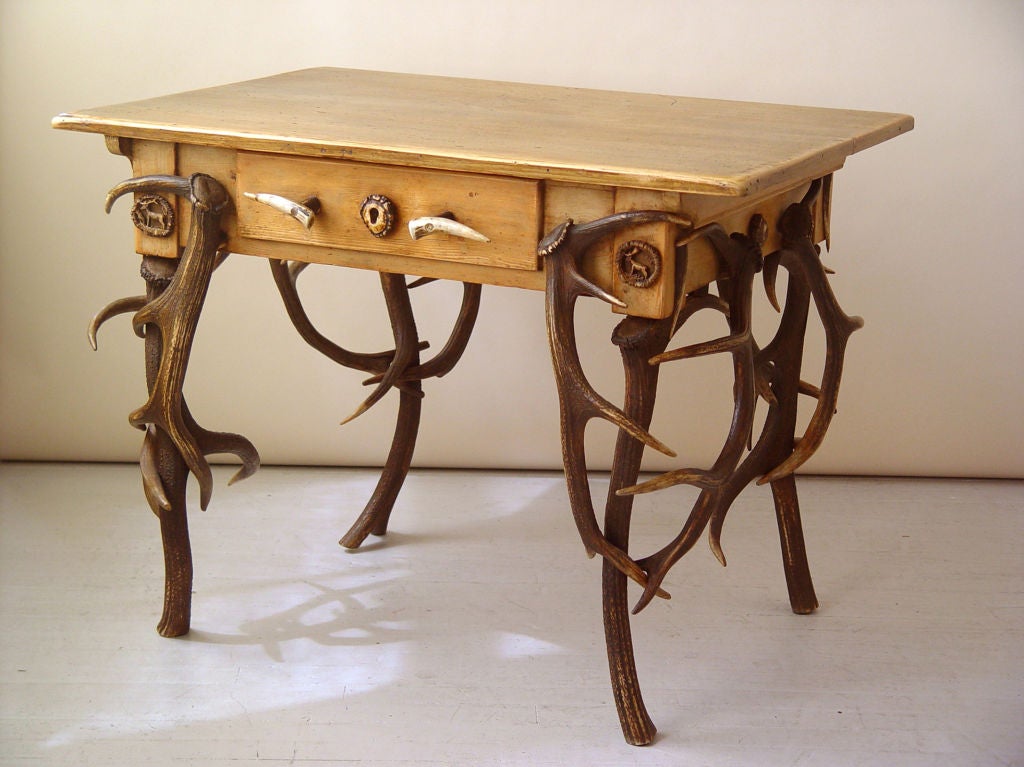 A 19th century pine top table with single drawer with antler legs & drawer pulls, Continental, 19th century<br />
Width-39 1/2