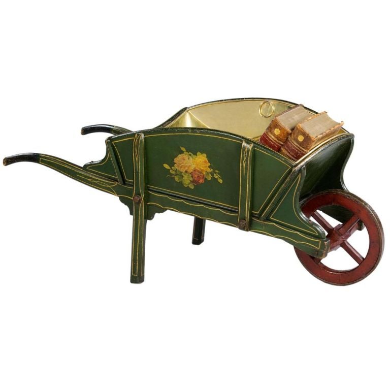 A charming mid 19th century painted library wheelbarrow decorated on the outside in green with floral ornament. The back inscribed 'T.H. Revell Rainsworth Notts'. The interior in burgundy red.