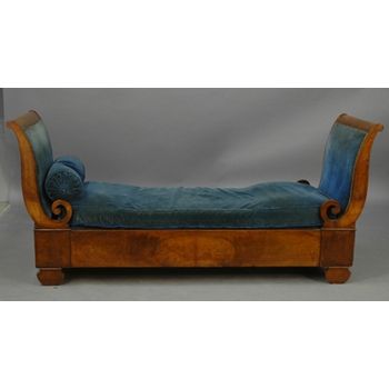 Made in France of the English Regency style, 19th Century walnut and blue upholstered sleigh daybed. Finished on both sides with scroll ends and interior swirl all resting on bracket feet. Seat height is 17