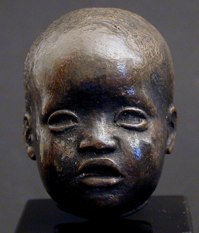 Diminutive and charming, this depiction of a small African American child is a rare find.  P. Fowler, the artist, makes reference to antique sculptures in the way he depicts the eyes of this child, suggesting that it was sculpted in the 1930s.