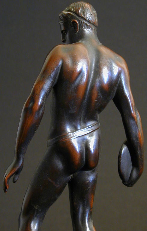 A fine example of the early 20th century artist's fascination with the idealized male figure and virile athleticism, this lovely bronze by Ludwig Eisenberger depicts a discus thrower readying for the toss.  The patina is warm and lustrous, and the
