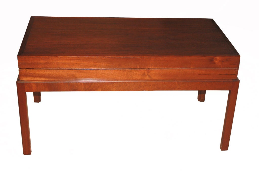 A mahogany folding Bagatelle case, on a later custom matching mahogany stand.  Perfectly adapted to serve as a low, coffee or drinks table for in front of a sofa; in a library or less-formal sitting room.