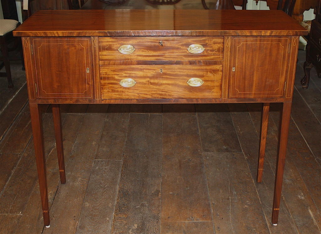 Made later than the Federal period, in the Hepplewhite manner; this inlaid mahogany huntboard replicates the original which was used for serving at hunt breakfasts.  Its design is in keeping with Mid-Atlantic and Southern pieces, likely of Baltimore
